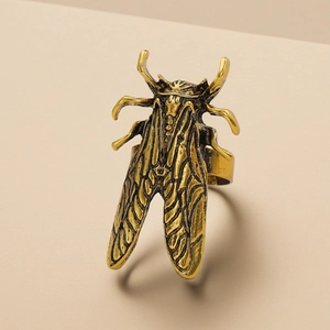 Detailed view of vintage beetle ring in antique gold finish with open adjustable band