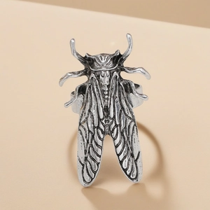 Macro detail of a vintage silver cicada ring showing realistic insect wings and textures