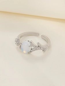Detail view of the vine-textured silver ring with an oval translucent gemstone inlay
