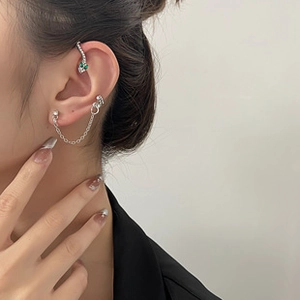 Silver snake ear cuff with emerald green gemstone eyes and delicate metal drop chains
