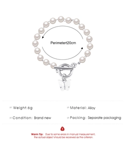 Detailed view of pearl bracelet with silver butterfly charm and OT toggle clasp specifications