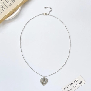 Silver hollow heart necklace with mother and child silhouette pendant on white background
