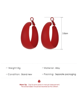 Detail view of large matte red C-shaped hoop earrings with size 3.8cm specifications
