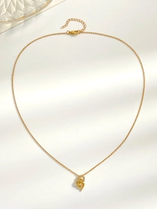 Detailed view of gold intertwined heart pendant necklace with shimmering white zircon stones
