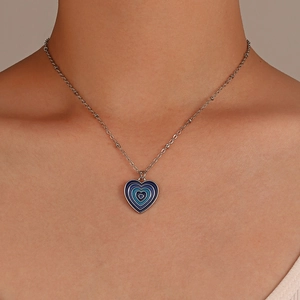 Close-up of blue gradient heart pendant necklace with elegant silver-colored chain detail