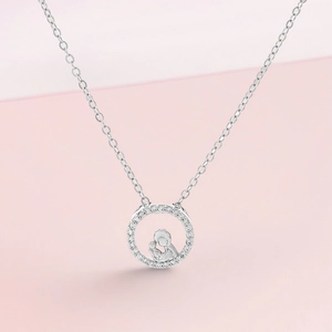 Macro view of silver mother and child pendant with pavé zirconia on O-chain