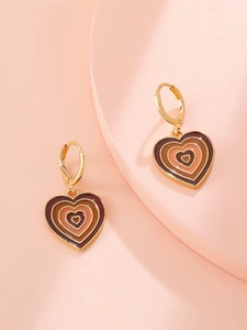 Detailed macro view of vintage heart earrings with gradient enamel layers and gold metal