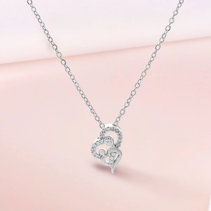 Detail of silver heart necklace with mother and child pendant and sparkling zircon stones