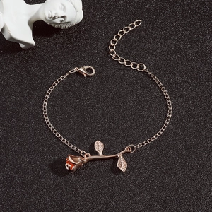 Detailed view of rose gold floral necklace with intricate rose pendant and leaf charms