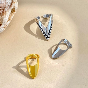 Detailed view of bohemian V-shaped beaded ring and minimalist gold fingertip nail rings
