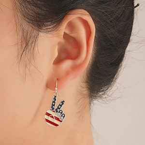 Detail of USA flag peace sign earring with blue stars, red stripes and white rhinestones