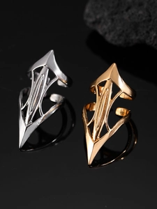 Detailed view of geometric pointed finger armor rings in polished gold and silver finishes