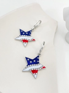 Macro detail of star-shaped earrings with American flag enamel and pavé rhinestones