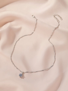 Detailed view of silver six-prong cubic zirconia pendant with adjustable twisted chain