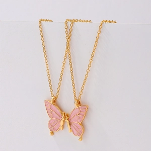Detail van roze emaille vlinder hanger ketting set in gouden legering afwerking