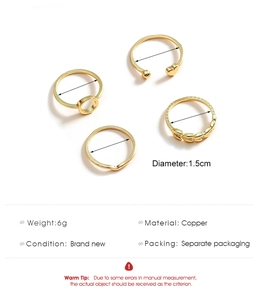 Detail view of 4-piece gold copper ring set with heart and leaf textured designs