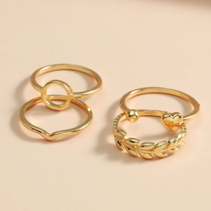 Golden 4-piece ring set with minimalist heart and olive leaf designs for women