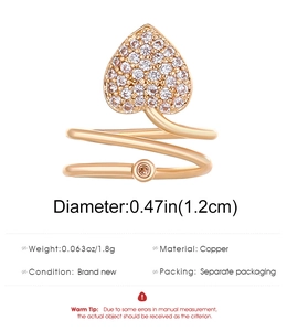 Macro detail of copper wrap ring featuring cubic zirconia heart and size dimensions
