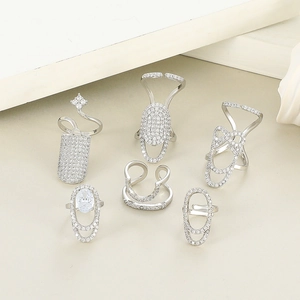 Detail of silver-plated adjustable nail rings with white zircons in geometric shapes