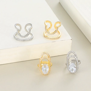 Close-up of geometric double-layer nail rings with sparkling zircon inlay in gold and silver