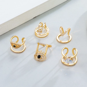 5-piece gold ear cuff set with evil eye, heart, and geometric rhinestone details