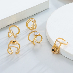 Set of five gold ear cuffs featuring evil eye designs and sparkling teardrop zircon