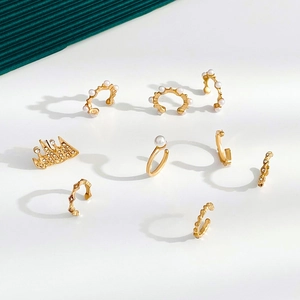 Detailed view of nine-piece gold ear cuff set featuring faux pearls and geometric designs