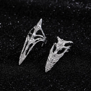 Gothic silver metal claw ring and skeleton ring set with white gems on black glitter
