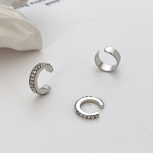 Close-up of three-piece silver ear cuff set with micro-pave zircons and polished finish
