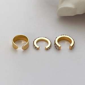 Detailed set of three gold C-shaped ear cuffs with pavé-set clear cubic zirconia
