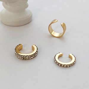 Detail of three-piece gold ear cuff set with polished and zircon micro-pave finishes