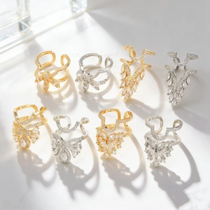 Macro shot of gold and silver butterfly wing rings with pavé cubic zirconia stones