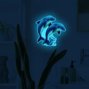 Luminous blue cartoon dolphin wall stickers glowing in a dark bedroom setting