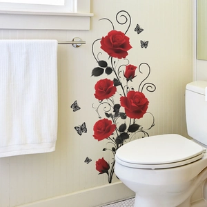 Detail of red rose and black butterfly wall stickers on a white bathroom wall tile