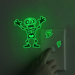 Luminous cartoon skull and lightning wall sticker glowing green on a bedroom switch