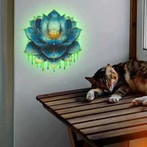 Glow-in-the-dark lotus wall sticker with blue petals and golden accents on a white wall