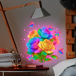 Luminous wall stickers featuring colorful roses and butterflies with glow effect in bedroom