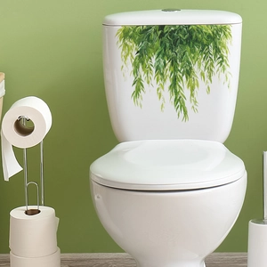 Self-adhesive green leaf wall sticker for bathroom decor on white toilet tank surface