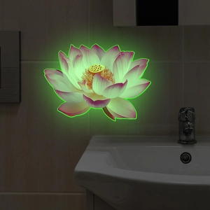 Close-up of luminous lotus wall sticker glowing green in a dark bathroom setting
