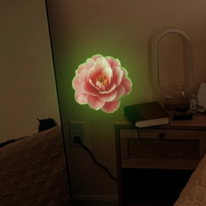 Luminous camellia wall sticker with pink petals and glowing green edges for home decor