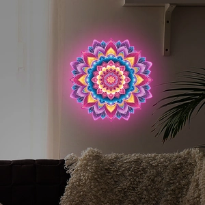 Detail of creative neon mandala wall sticker glowing with pink and blue lights on a wall