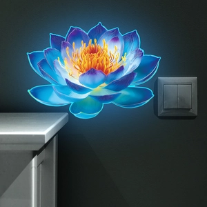 Glow in the dark lotus wall sticker with neon blue and purple petals on a grey wall