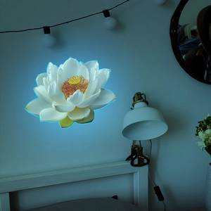 Luminous lotus wall sticker detail showing blue glowing edges in a cozy bedroom setting