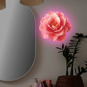 Close-up of glowing pink floral wall decoration with LED neon light in home setting