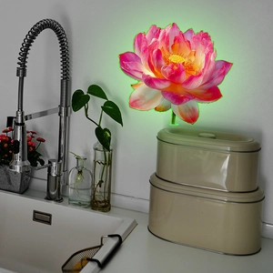 Detailed view of luminous pink lotus wall sticker glowing on a modern kitchen backsplash