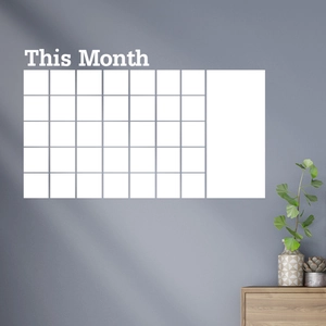 Minimalist white wall sticker monthly calendar with This Month text on grey wall background