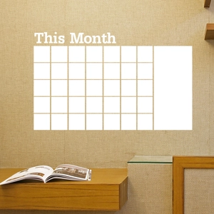 Close-up of the monthly planner wall sticker with a 7x5 grid and memo area on a textured wall
