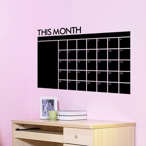 Close-up of black monthly calendar wall sticker with This Month header on a pink wall