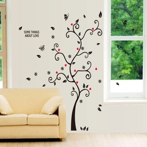 Modern family photo frame tree wall decal with black leaves and red hearts on a beige wall