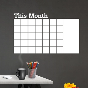 Detail view of monthly planner wall sticker featuring a grid and This Month text on dark wall